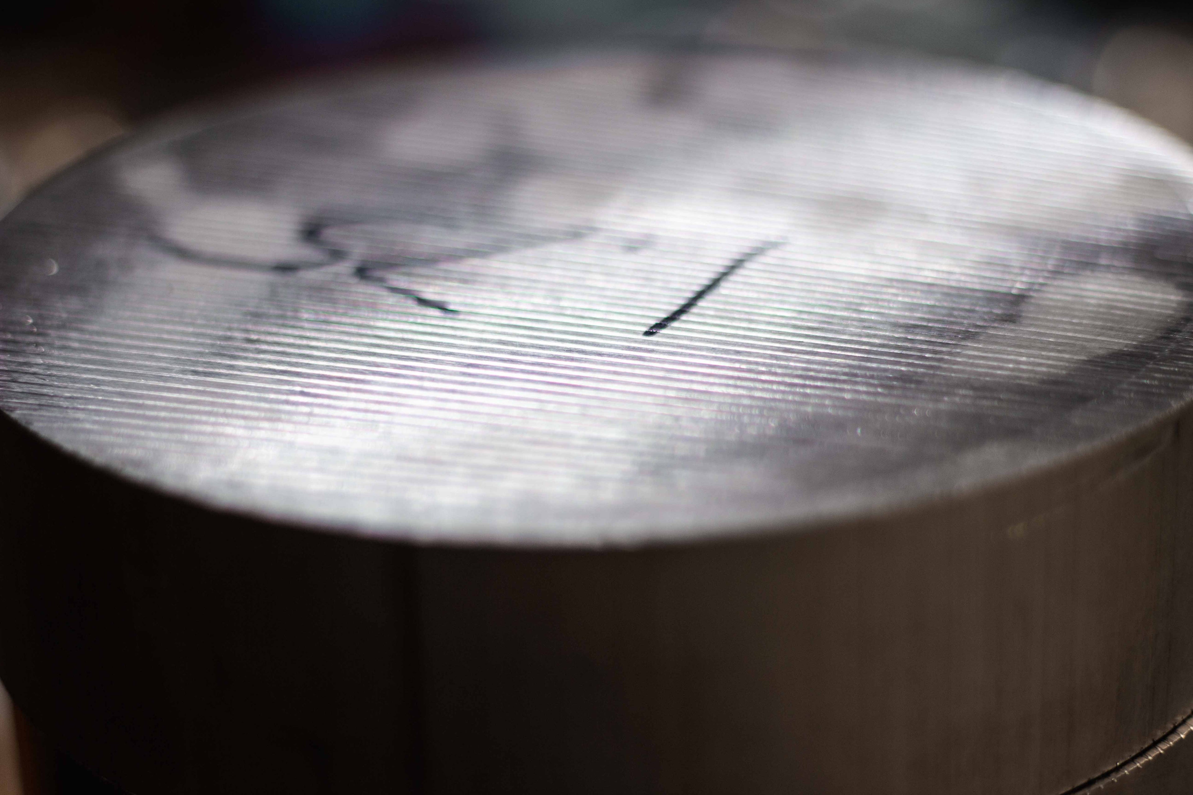 Close-up of a raw billet aluminum chunk before machining at BSB USA.
