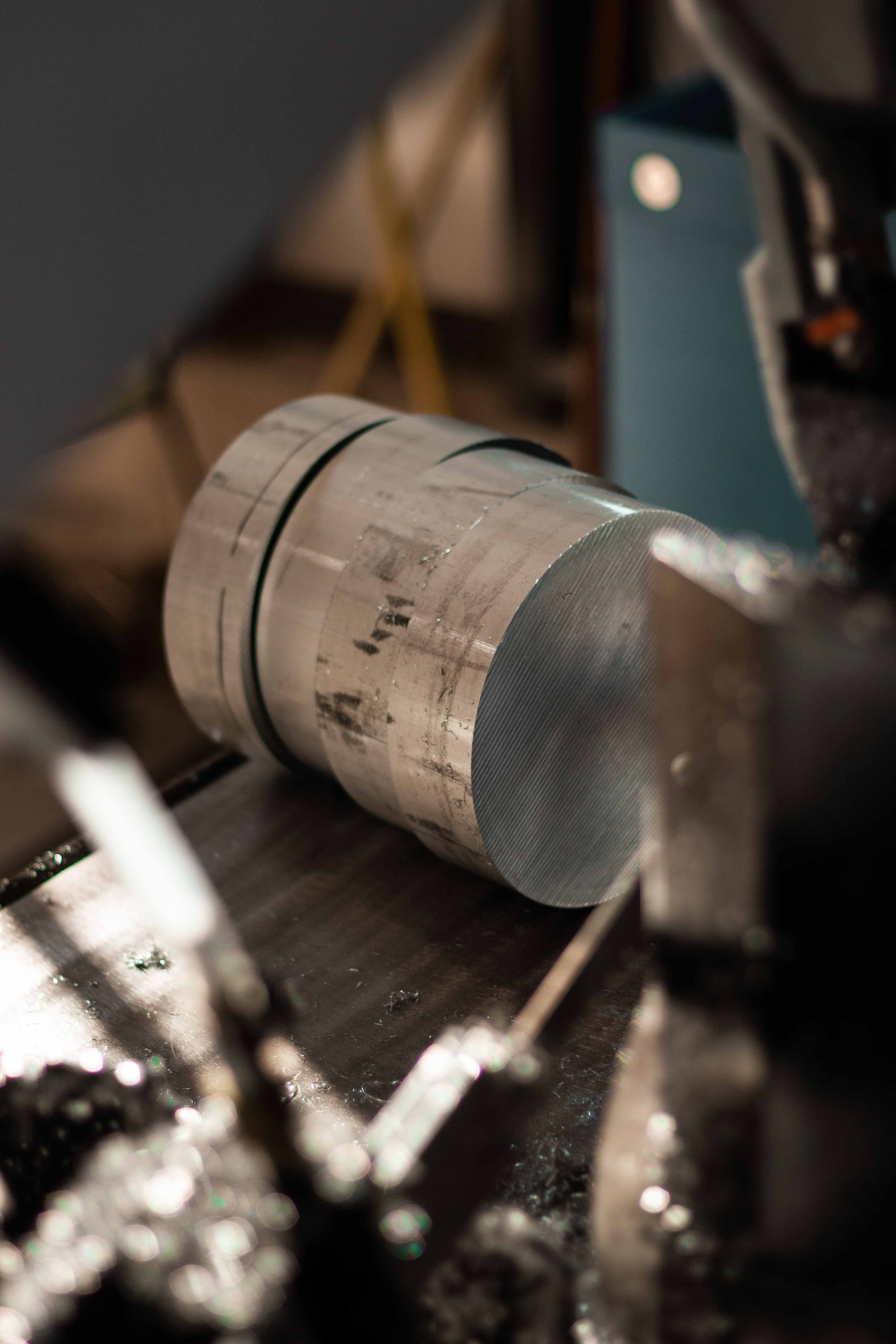 Raw aluminum blanks sitting on saw after cutting at BSB USA.