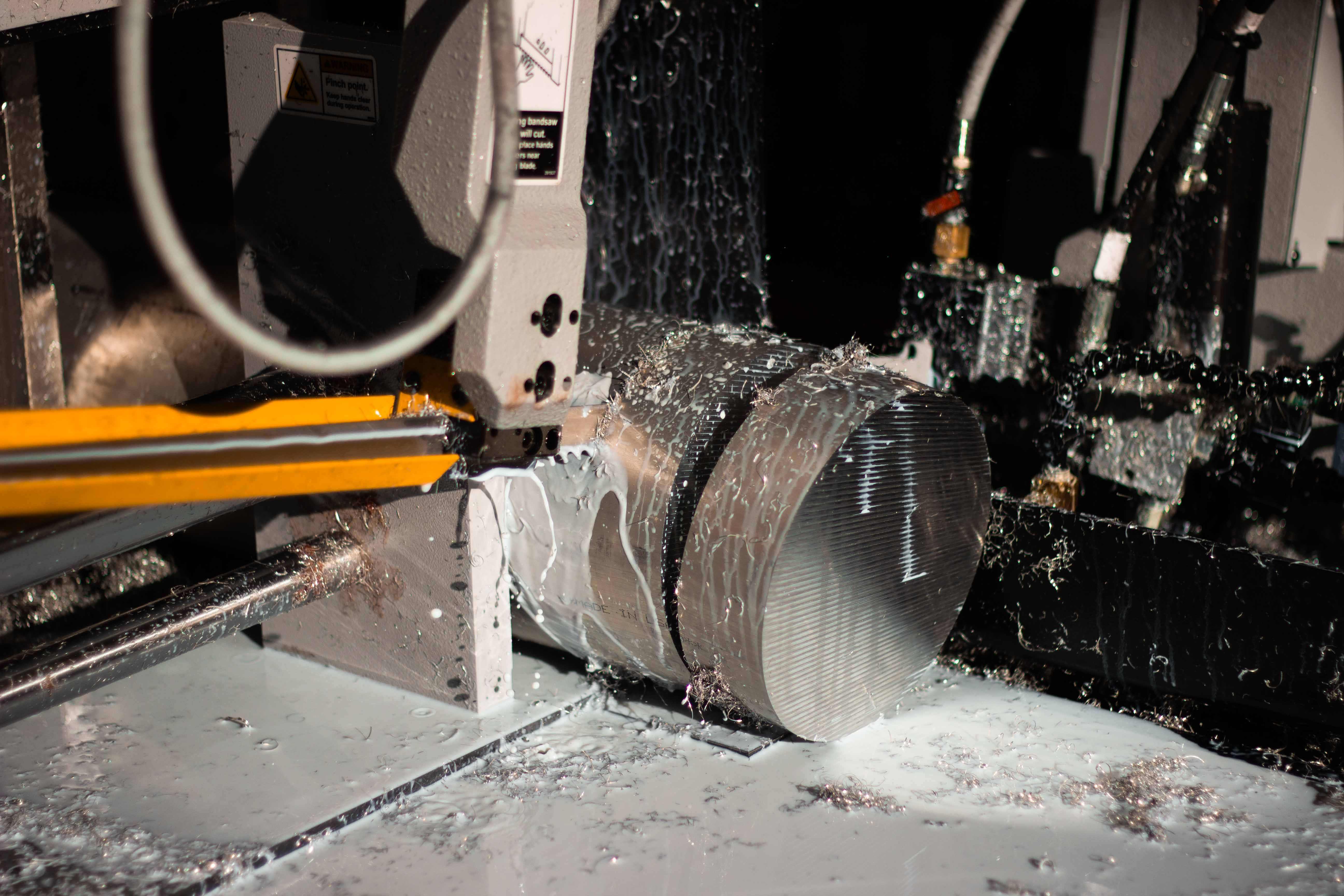 Aluminum blanks being cut on a saw at BSB USA.